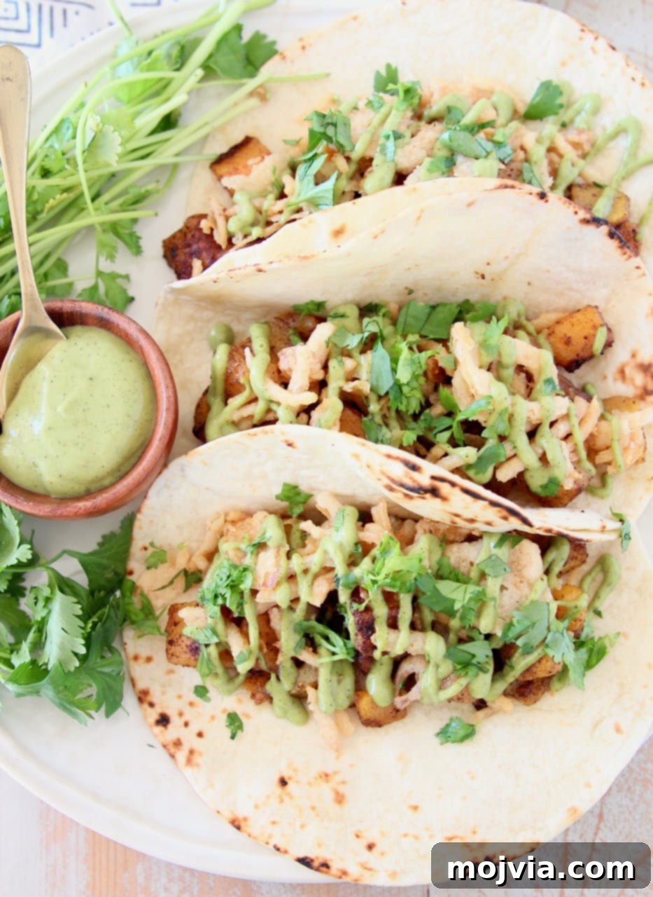 Roasted Butternut Squash Tacos 4 Butternut squash tacos in flour tortillas with creamy avocado sauce and fresh cilantro