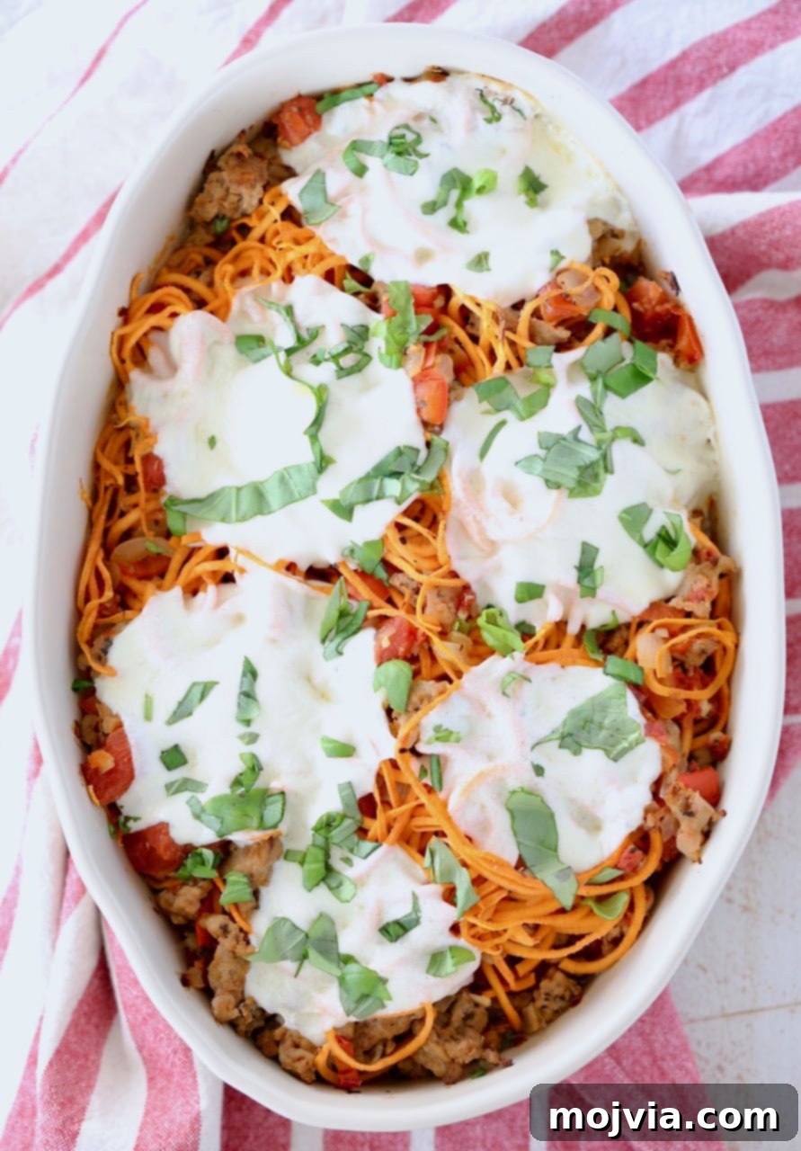 Tuscan Turkey Sweet Potato Bake 3 Italian casserole with sweet potato noodles, topped with perfectly melted mozzarella cheese in an oval baking dish, ready to serve.
