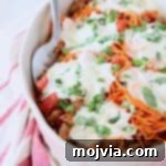 Tuscan Turkey Sweet Potato Bake 6 Italian casserole with sweet potato noodles and mozzarella cheese in oval white baking dish