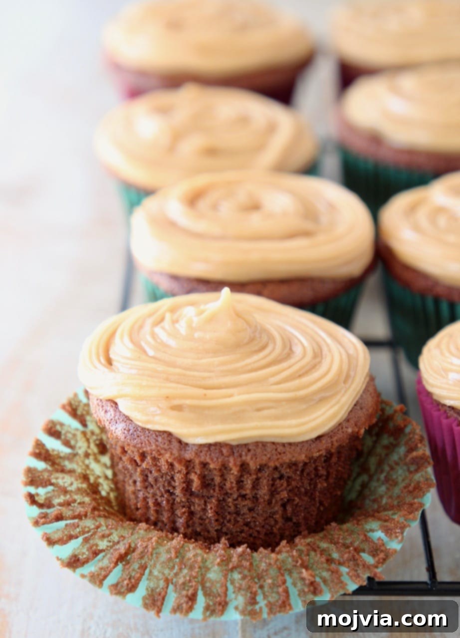 Wholesome Peanut Butter Chocolate Gluten Free Delights 5 Chocolate cupcake with peanut butter frosting, sitting on cupcake liner, peeled from the cupcake