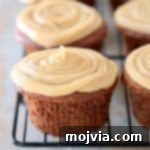 Wholesome Peanut Butter Chocolate Gluten Free Delights 6 Chocolate cupcake with peanut butter frosting on black wire baking rack