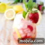 Fresh lemons and strawberries are mixed with bubbly prosecco for a refreshing proseria recipe that is perfect for spring and summer!