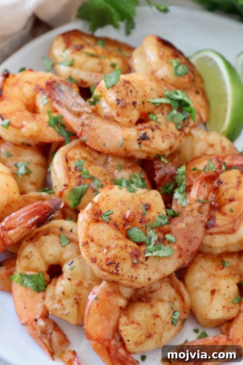 Perfectly grilled shrimp served on a plate with fresh lime wedges, highlighting the vibrant colors and succulent texture.