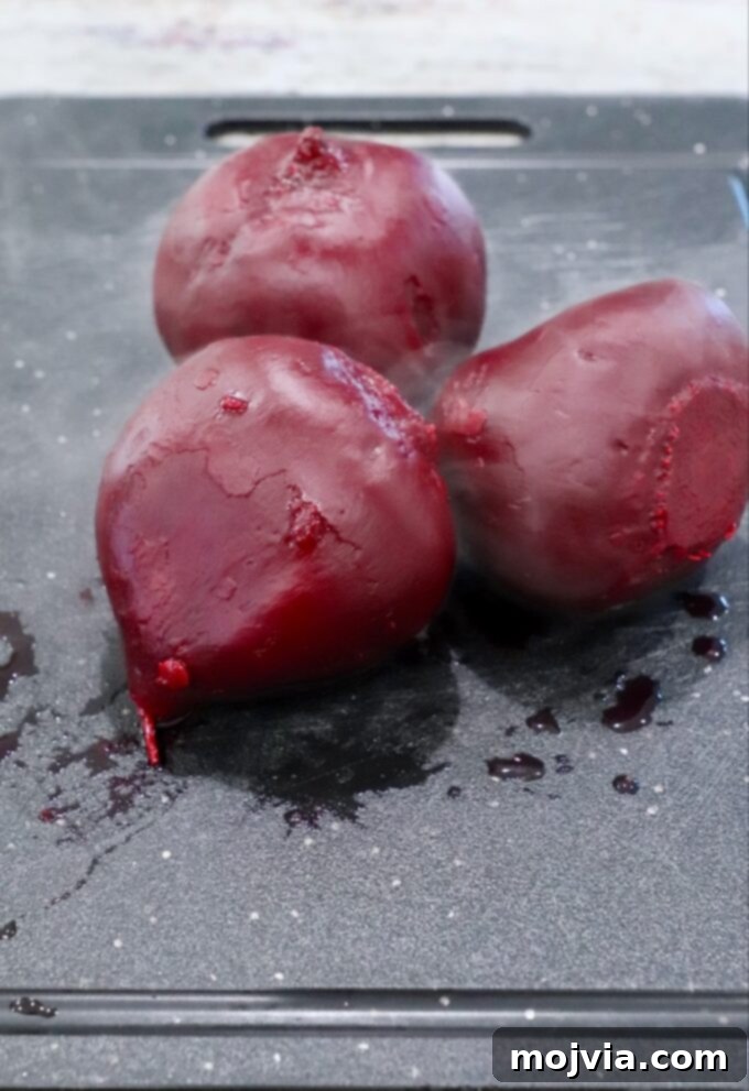 Blush Beet Hummus 6 Peeled and steamed beets on a cutting board, prepared for dicing.