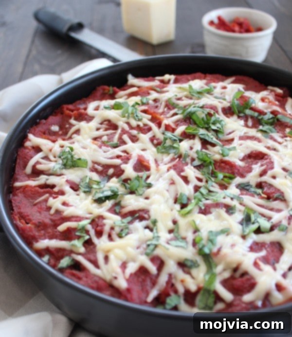 Sun-Drenched Sausage & Cheese Pasta Shells 12 Exquisite Stuffed Shells with Red Wine Tomato Sauce, perfectly baked in a baking dish and garnished with fresh basil, ready to be served.
