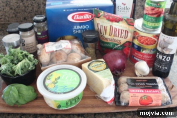 Sun-Drenched Sausage & Cheese Pasta Shells 3 A beautiful flat lay of all the fresh ingredients needed for Mediterranean Stuffed Shells, including pasta, sausage, vegetables, and cheeses.