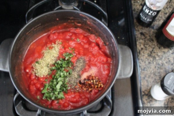 Sun-Drenched Sausage & Cheese Pasta Shells 5 Rich red wine tomato sauce simmering gently in a pot on the stove, infusing the kitchen with delightful aromas.