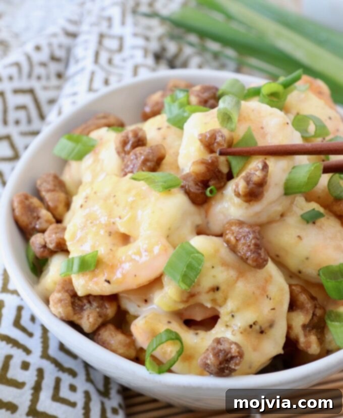 Golden Honey Walnut Prawns 2 honey walnut shrimp in bowl with chopsticks