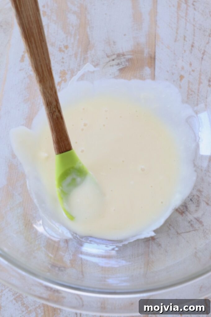 Golden Honey Walnut Prawns 4 honey and mayonnaise combined in bowl with spatula