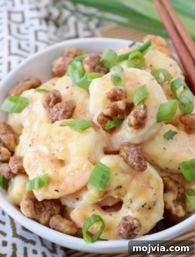 Golden Honey Walnut Prawns 10 honey walnut shrimp in bowl topped with diced green onions