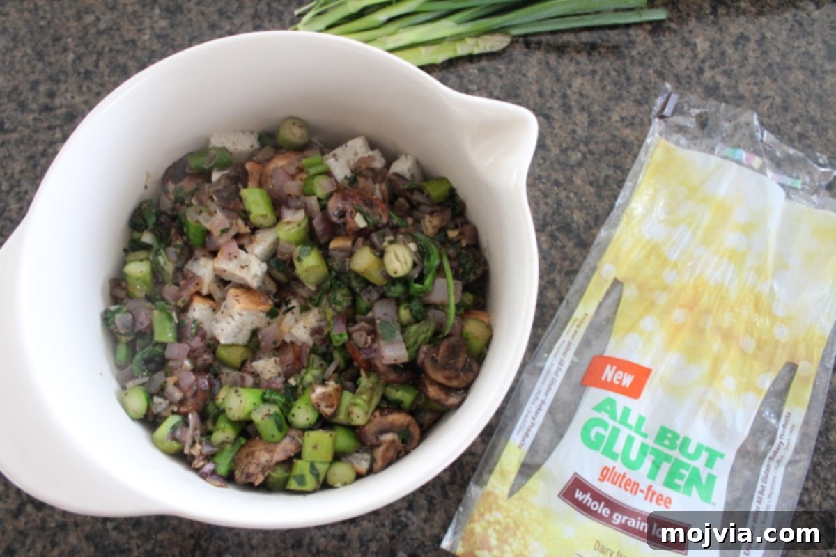 Vibrant Spring Garden Gluten Free Stuffing 6 Transferring vegetables to a bowl with cubed gluten-free bread