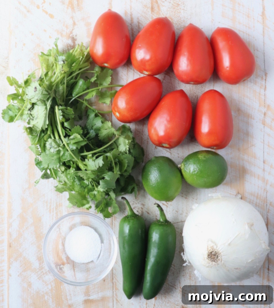 Your Go-To 10-Minute Fresh Salsa 3 Fresh ingredients laid out for making homemade tomato salsa: Roma tomatoes, jalapeños, white onion, cilantro, and lime.
