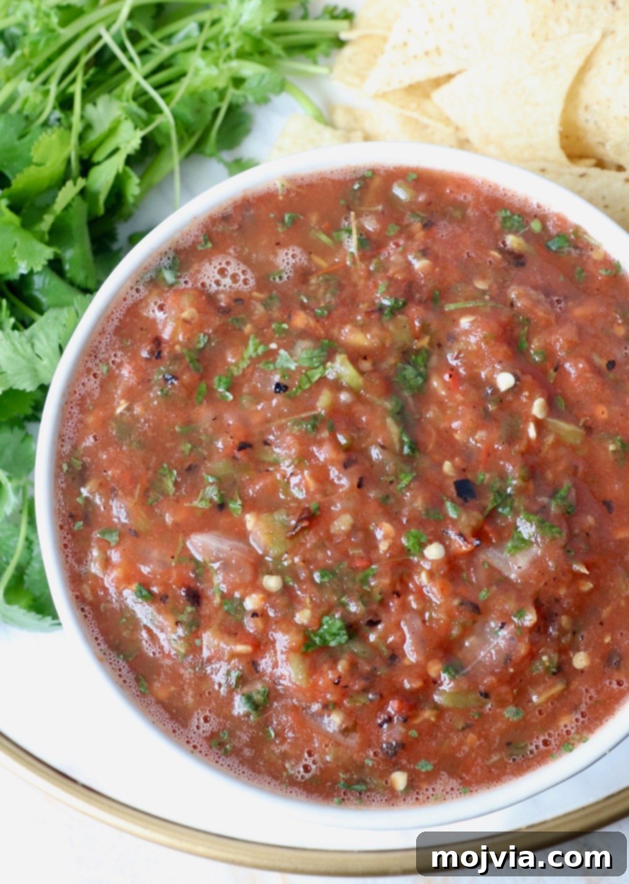 Your Go-To 10-Minute Fresh Salsa 5 A beautiful white bowl filled with chunky, flavorful homemade tomato salsa, ready to be enjoyed with tortilla chips.
