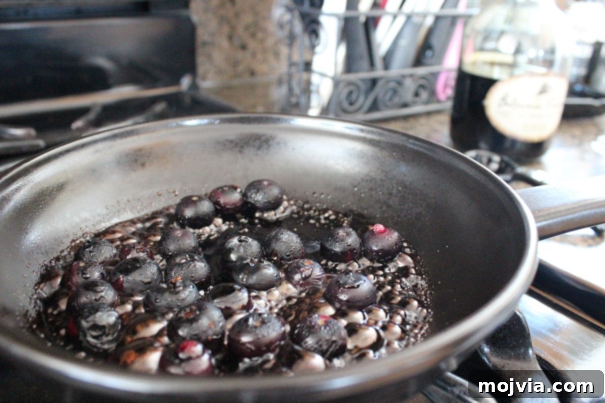 Blueberry BBQ Glazed Grilled Salmon 5 Blueberry BBQ Sauce Recipe - Balsamic and apple cider vinegars being added to the simmering blueberries.