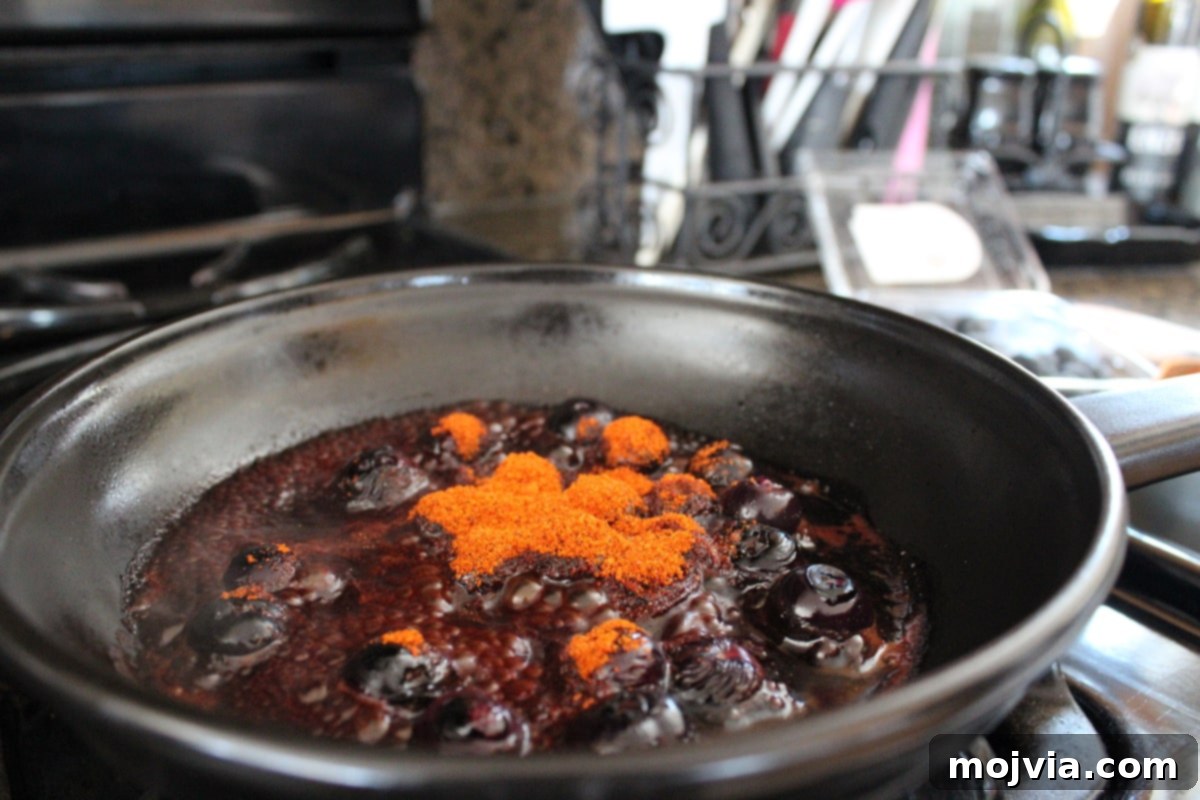 Blueberry BBQ Glazed Grilled Salmon 6 Blueberry BBQ Sauce Recipe - BBQ seasoning being stirred into the blueberry and vinegar mixture.
