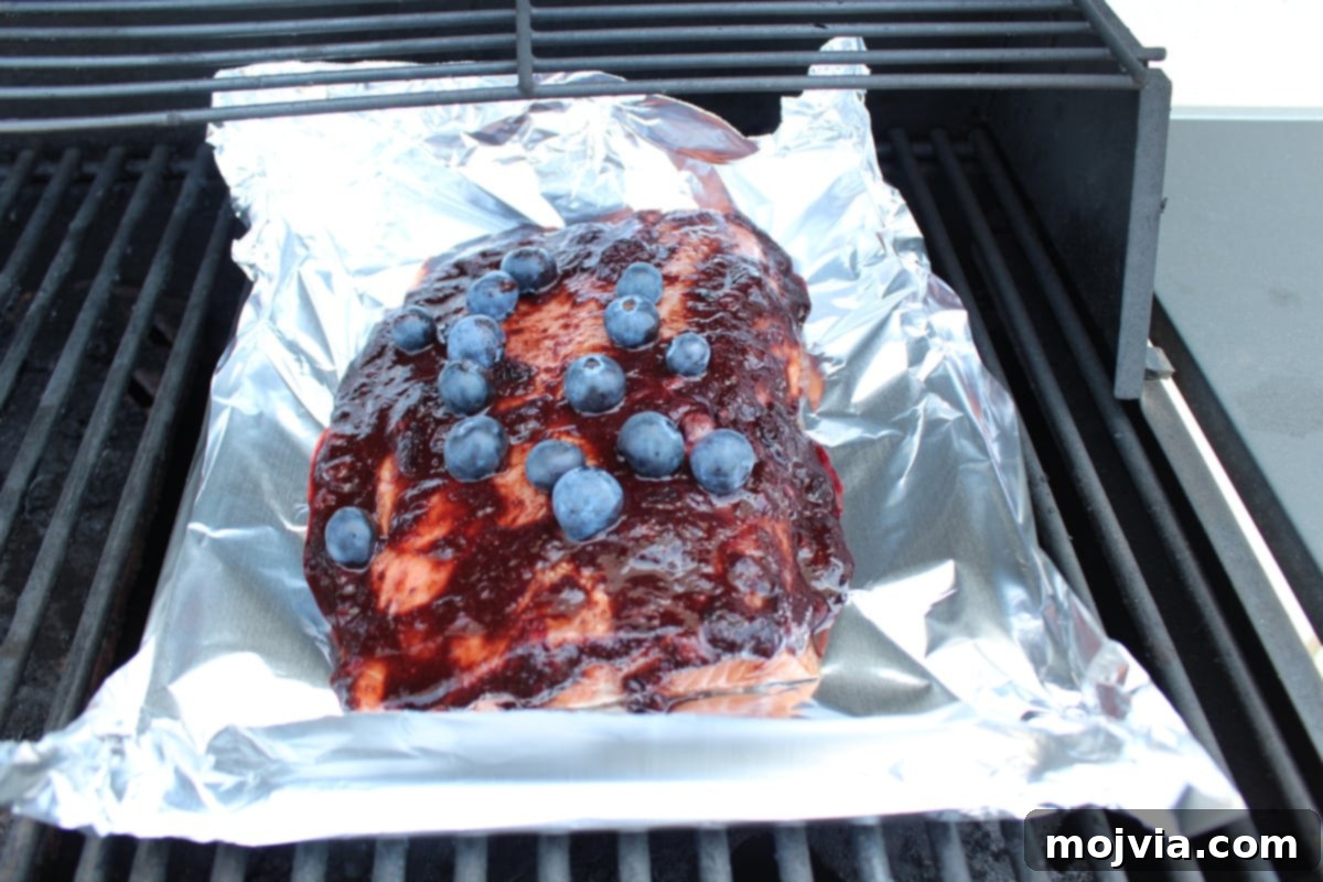 Blueberry BBQ Glazed Grilled Salmon 9 BBQ Grilled Salmon cooking on the grill in a foil basket.
