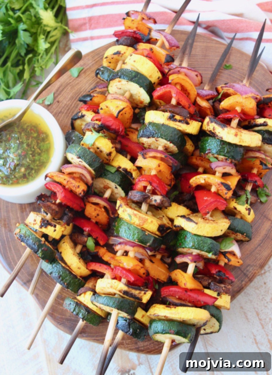 Vibrant Grilled Vegetable Skewers 6 A wooden serving tray holds several grilled vegetable skewers, with a small bowl of chimichurri sauce on the side for dipping, ready to be enjoyed.