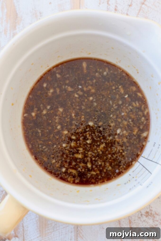 Zesty Gluten-Free Orange Chicken 4 Orange sauce ingredients being mixed in a bowl