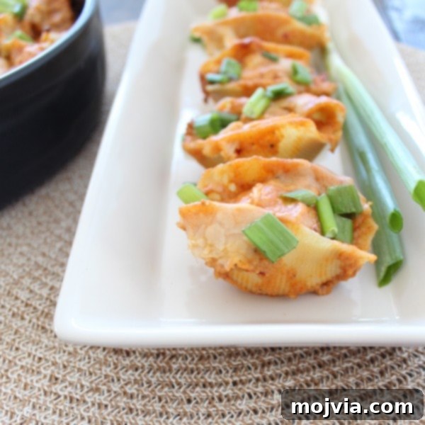 Close-up of a single Buffalo Chicken Alfredo Stuffed Shell on a plate.