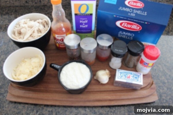 Ingredients laid out for Buffalo Chicken Alfredo Stuffed Shells recipe.
