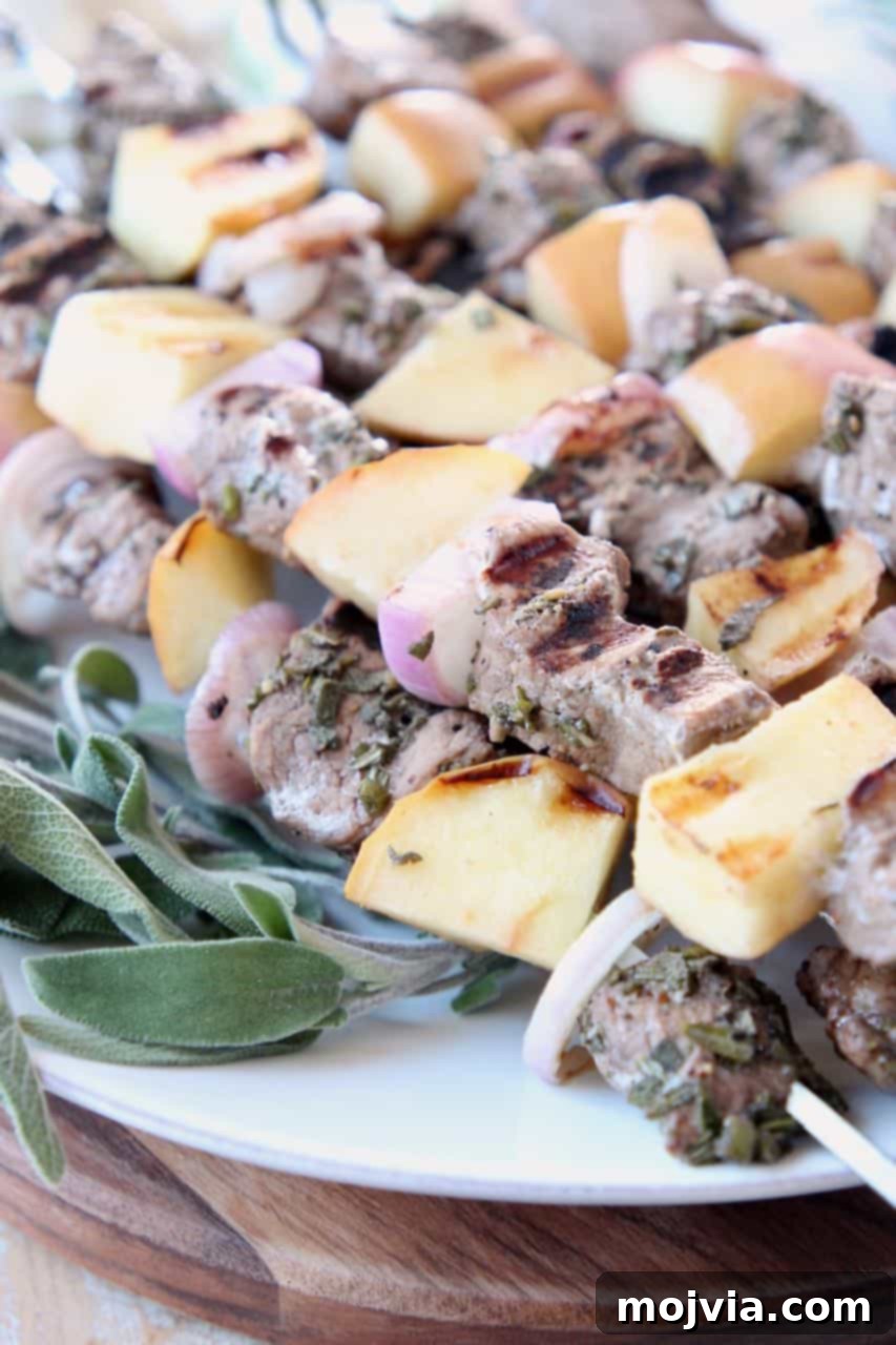 Fragrant Rosemary Sage Pork Skewers 4 Grilled pork and apple skewers garnished with fresh sage leaves