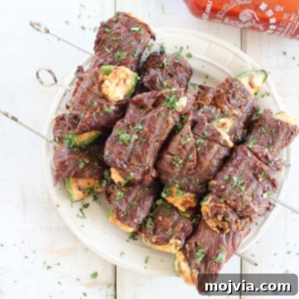 Smoky Sriracha Steak Popper Skewers 3 A close-up of a beautifully grilled Sriracha Steak Wrapped Jalapeño Popper skewer
