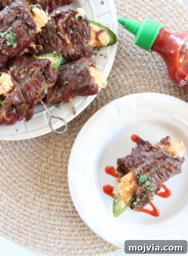 Smoky Sriracha Steak Popper Skewers 4 Several Sriracha Steak Wrapped Jalapeño Popper skewers ready for grilling