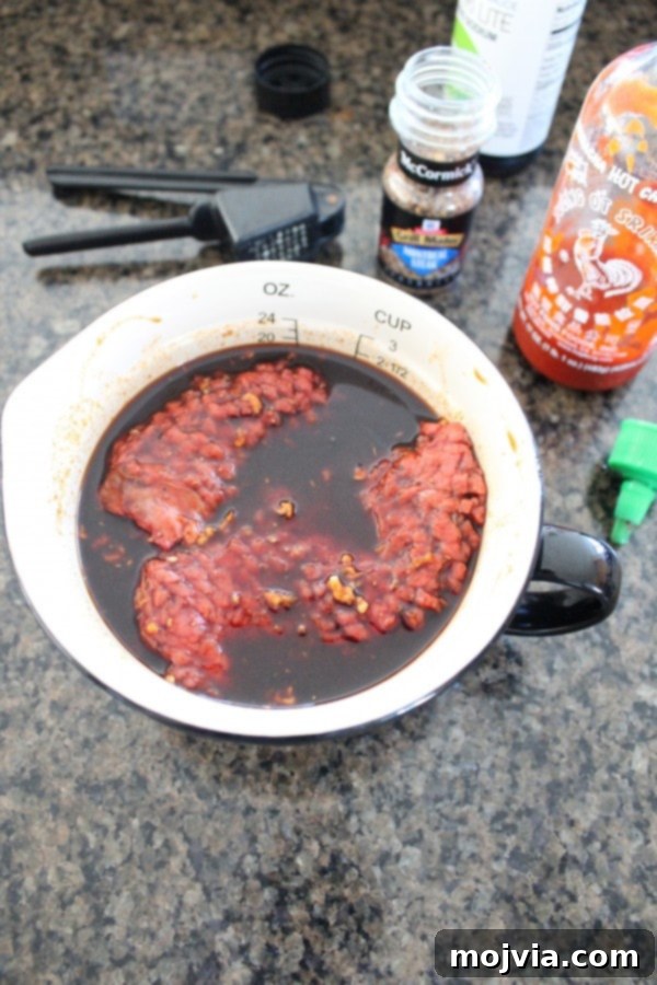Smoky Sriracha Steak Popper Skewers 8 Skirt steak marinating in sriracha and soy sauce