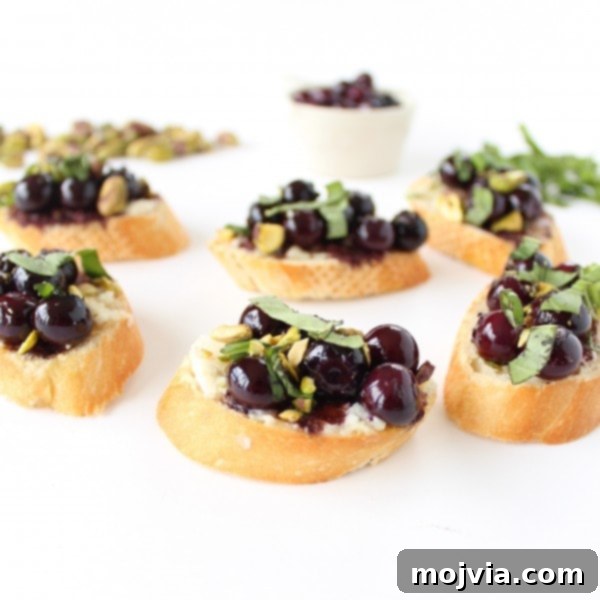 Sweet & Savory Blueberry Crostini with Goat Cheese and Pistachios 2 Completed Blueberry Goat Cheese Crostini with basil.