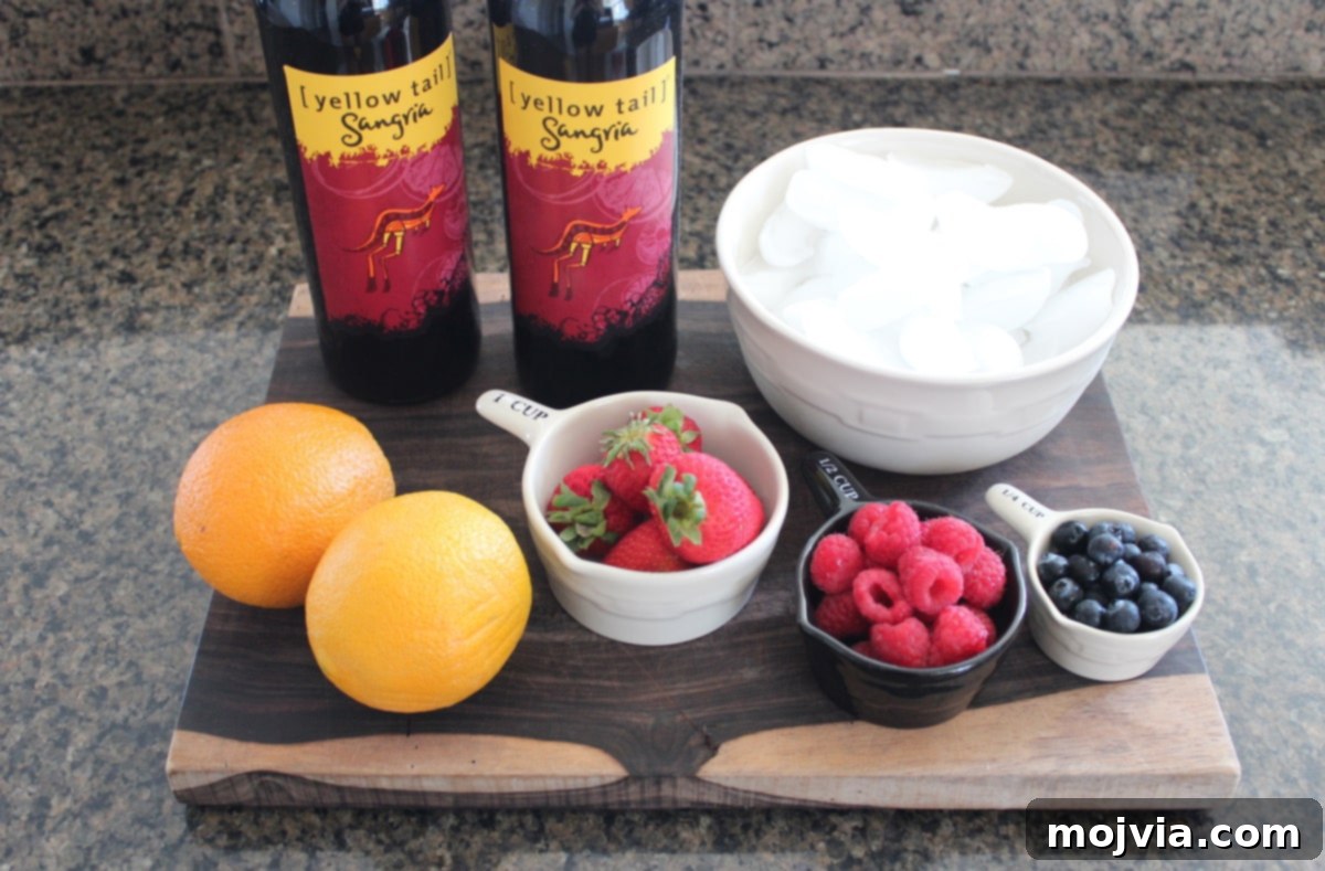 A selection of fresh berries, an orange, and a bottle of Yellow Tail Sangria arranged on a wooden board for preparing frozen sangria