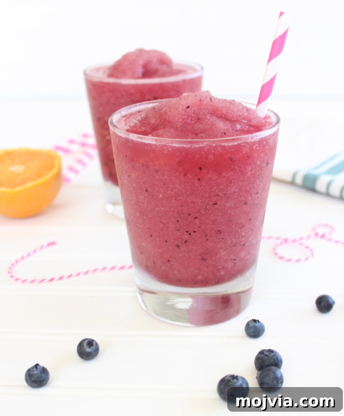 Another perspective of a glass of frozen sangria with fresh fruit garnish, highlighting its refreshing appeal