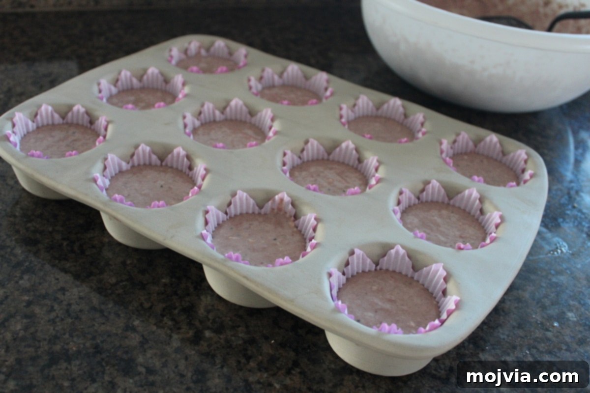 Zesty Strawberry Kiwi Cupcakes 7 Unbaked Strawberry Kiwi Cupcakes in a muffin pan