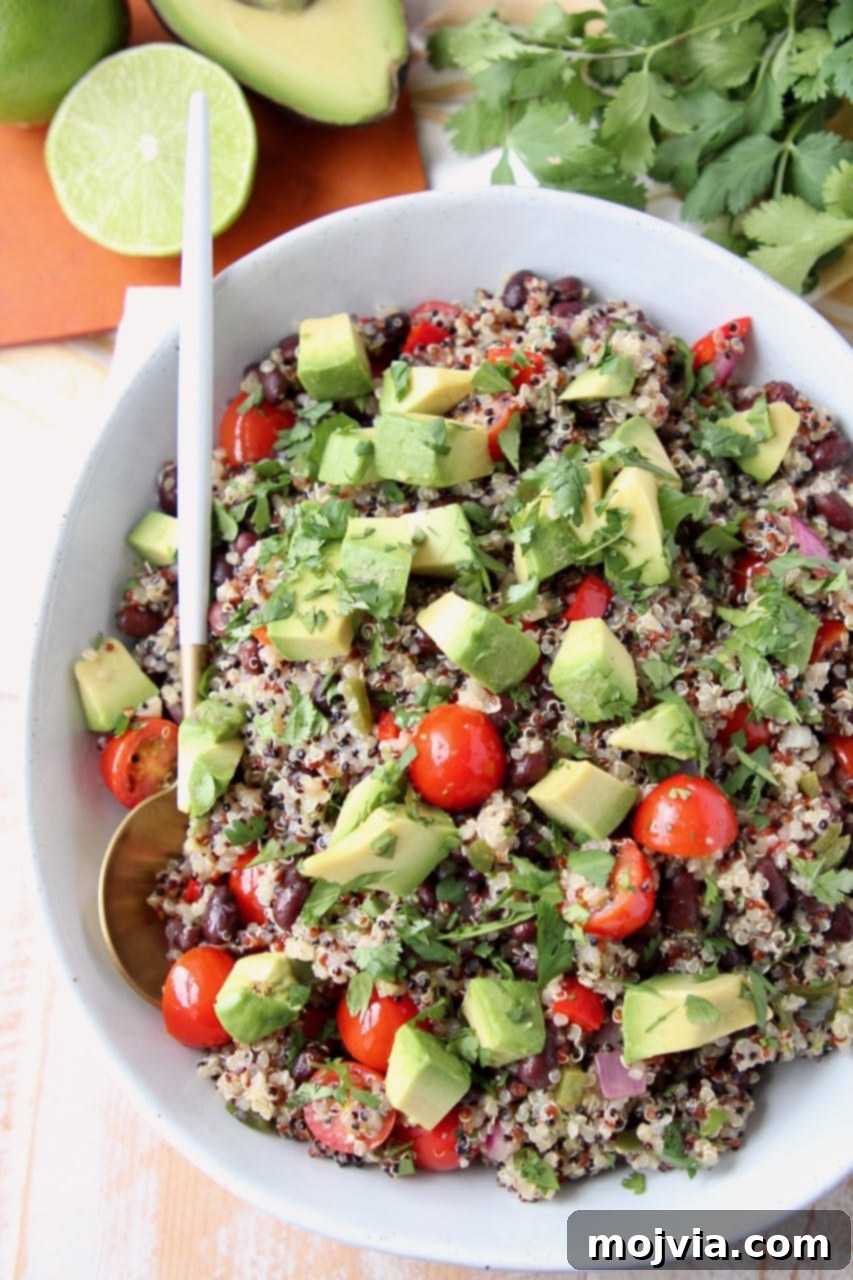 Fiesta Quinoa Salad 3 Overhead shot of quinoa salad in bowl with diced tomatoes and avocado