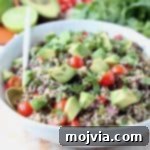 Fiesta Quinoa Salad 5 White bowl filled with quinoa salad with diced avocado and tomatoes