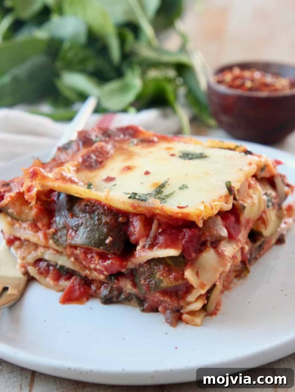 Green Goodness Lasagna 7 slice of vegetable lasagna on plate with fork