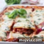 Green Goodness Lasagna 8 slice of vegetable lasagna being lifted out of casserole dish
