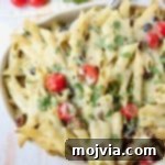 Close up of taco pasta with cherry tomatoes in a casserole dish