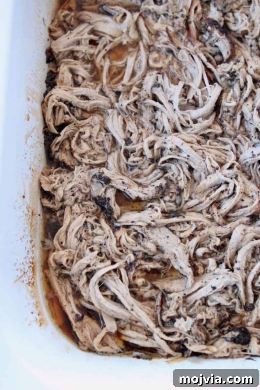 A slow cooker brimming with perfectly coffee-crusted pork tenderloin, ready to be shredded and enjoyed as delicious pulled pork.