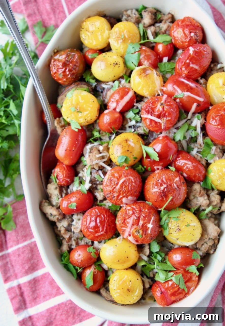 Italian Turkey Polenta Bake 2 Delicious Turkey casserole topped with vibrant roasted cherry tomatoes and fresh herbs, ready to be served.