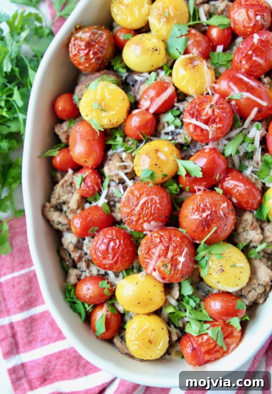 Italian Turkey Polenta Bake 5 Close-up of a casserole dish filled with savory Italian ground turkey, vibrant roasted cherry tomatoes, and garnished with fresh chopped parsley.
