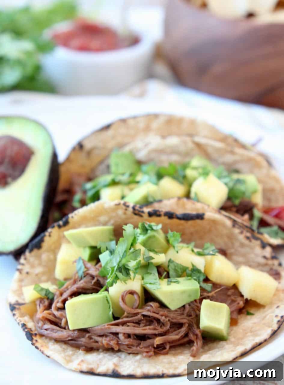 Crockpot Pulled Beef Tacos 2 Shredded beef tacos topped with diced pineapple and avocado