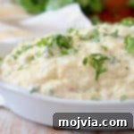 Roasted spaghetti squash tossed in a cheese sauce in a white baking dish