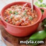 Chili in orange bowl with spoon