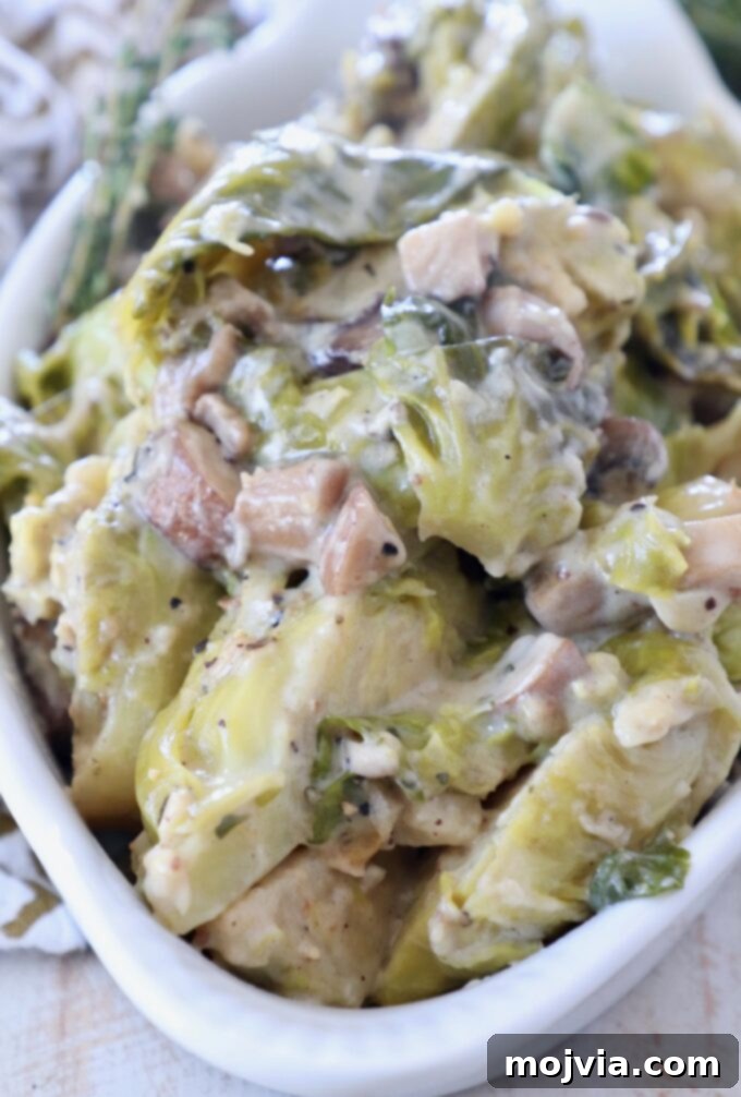 A perfectly baked, creamy brussel sprouts casserole in a white serving dish, bubbling and golden brown, ready to be enjoyed as a comforting vegetarian and gluten-free side dish.