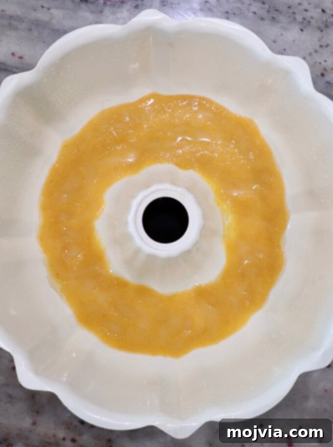 Half of the pumpkin butter mixture poured into the bottom of a bundt pan, ready for the biscuit layers.