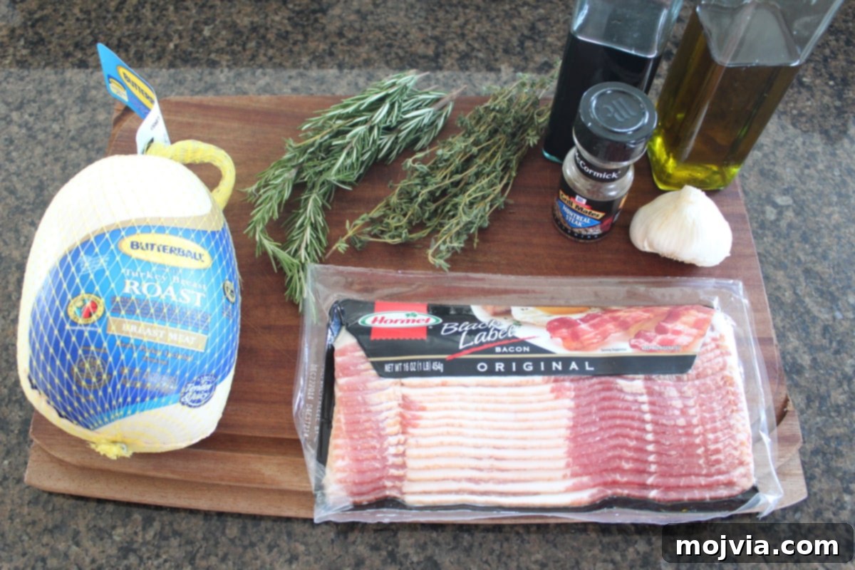 Golden Bacon Wrapped Turkey Breast 3 Ingredients for Bacon Wrapped Turkey Breast laid out on a wooden cutting board