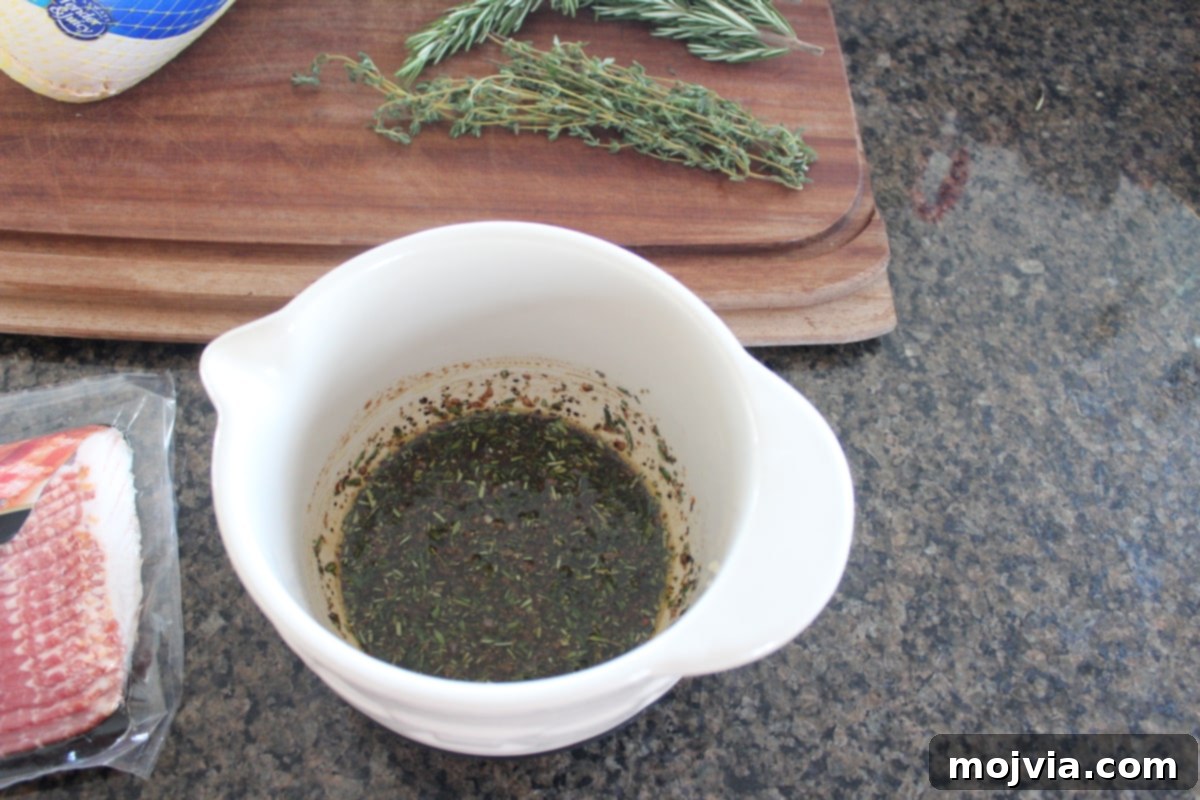 Golden Bacon Wrapped Turkey Breast 4 Balsamic vinegar, olive oil, and fresh herbs in a small bowl, ready for the rub.