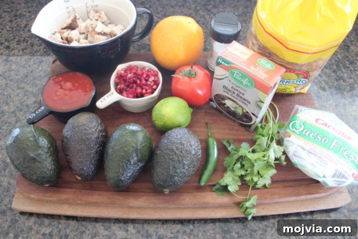 Ingredients for Turkey Tostadas including avocados, pomegranate, turkey, salsa, and tostada shells