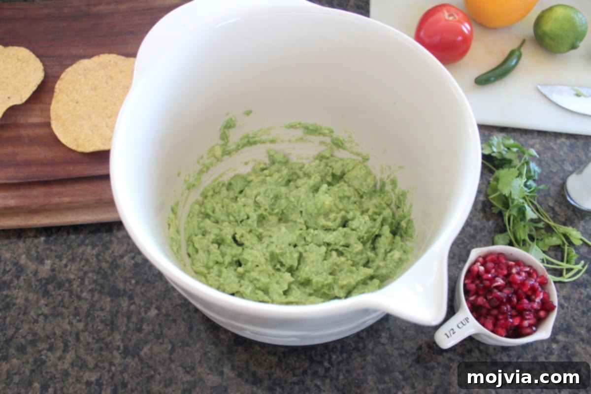 Mashed avocado in a large mixing bowl