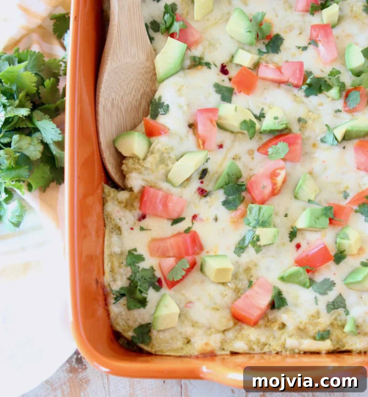 Cheesy Chicken Enchilada Bake 4 Generous serving of chicken enchilada casserole topped with fresh diced tomatoes and creamy avocado